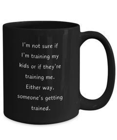 Funny Parent Mom Dad Ceramic Black Mug Training Kids or Kids Training Us